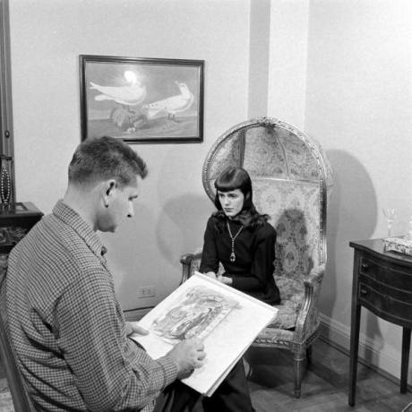Charles Addams sketching a model posing as Morticia Addams for "The Addams Family cartoon" (1946) 